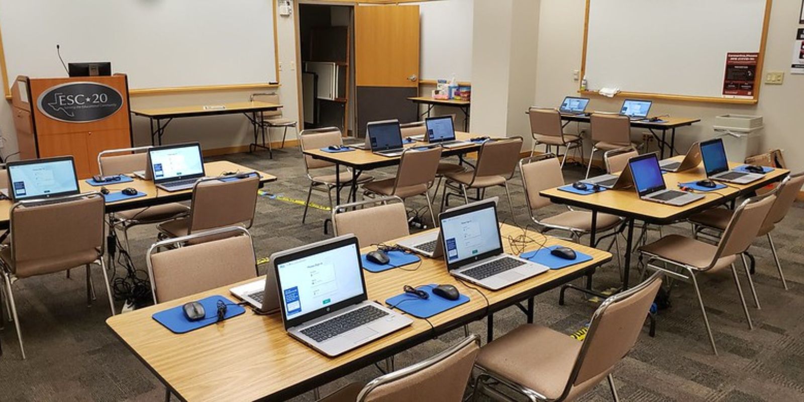 classroom set up for standardized tests on laptop computers