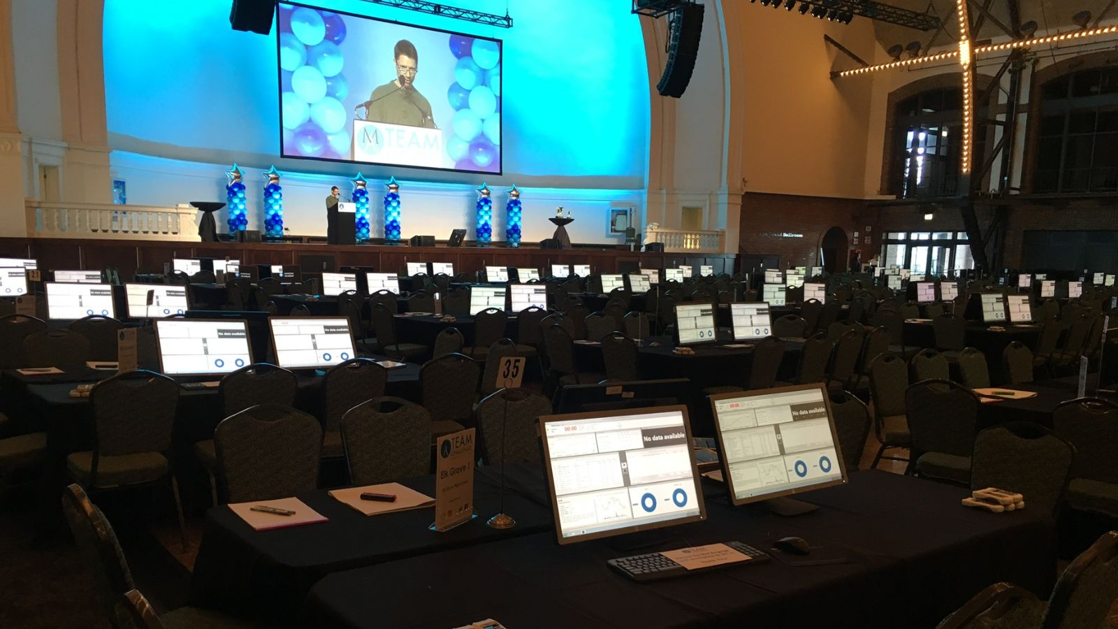 Room at the Chicago stock exchange filled with laptops and balloons on a stage
