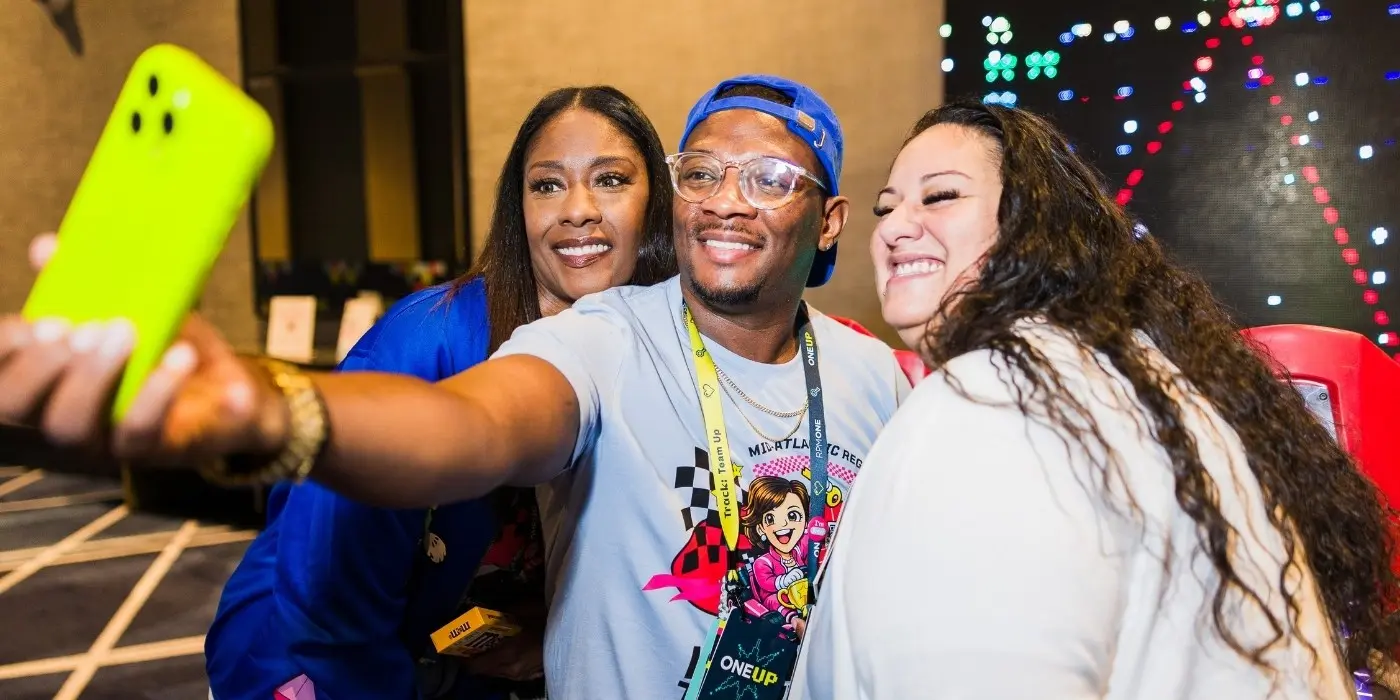 Conference attendees taking a selfie at a branded event
