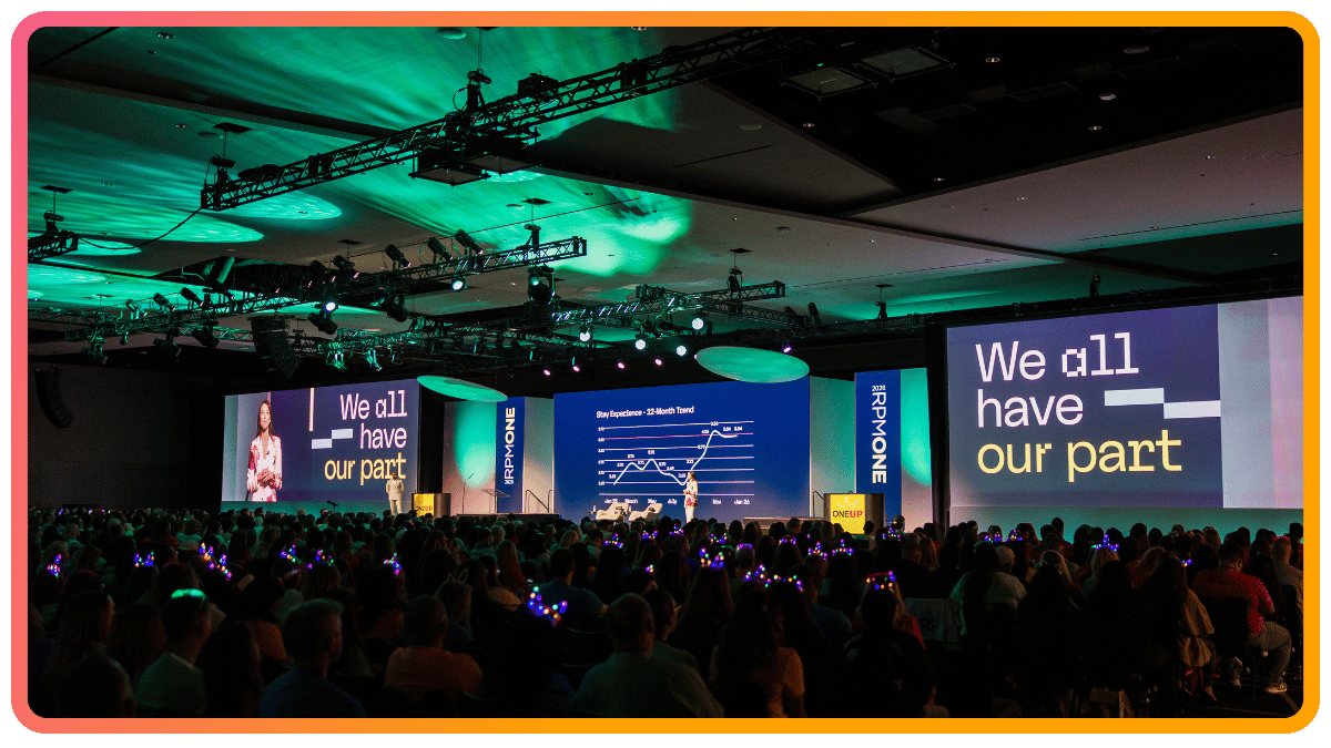 Large corporate general session with LED screens and light-up audience