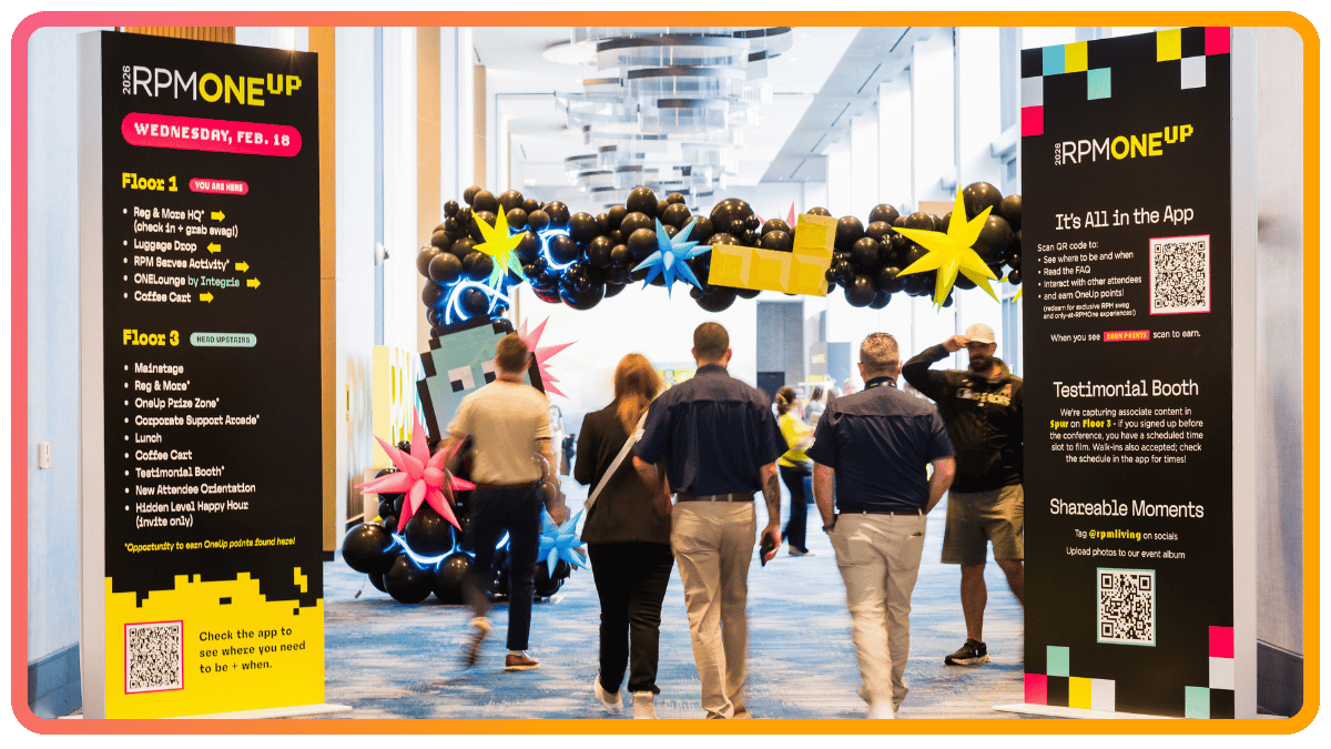 Attendees walking through a branded event hallway entrance