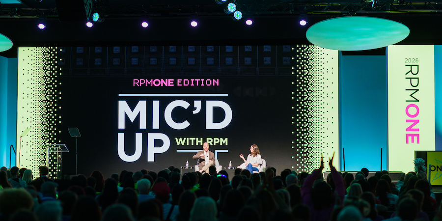 Two speakers on stage at branded corporate conference session