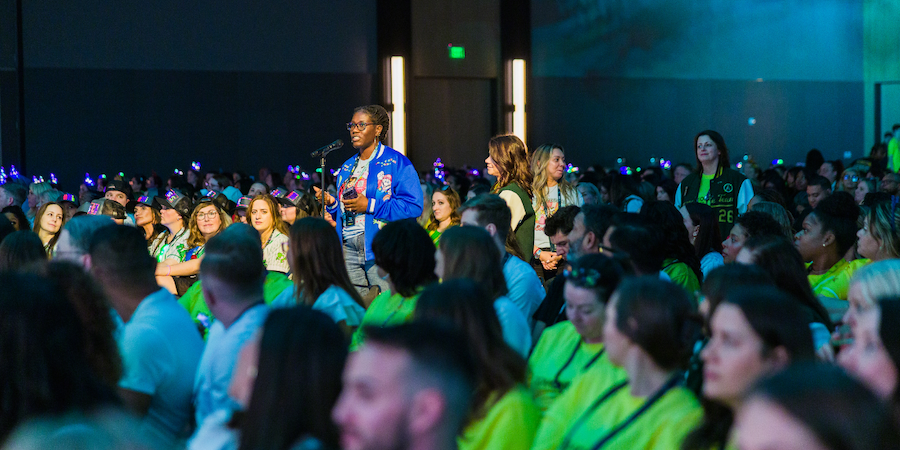 Attendee asking question at large corporate conference