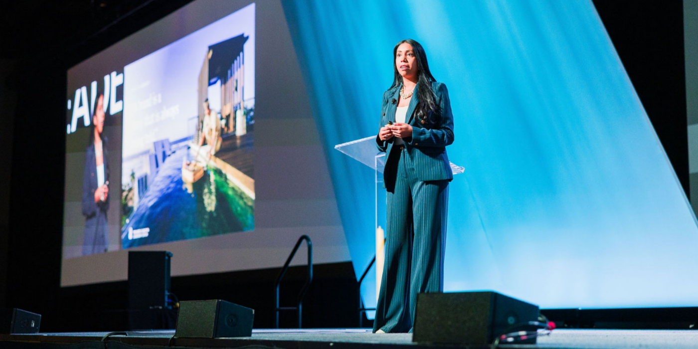 Female speaker presenting at corporate conference