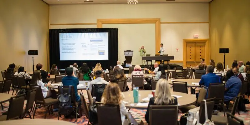 Presenters leading a session in a round-table setup