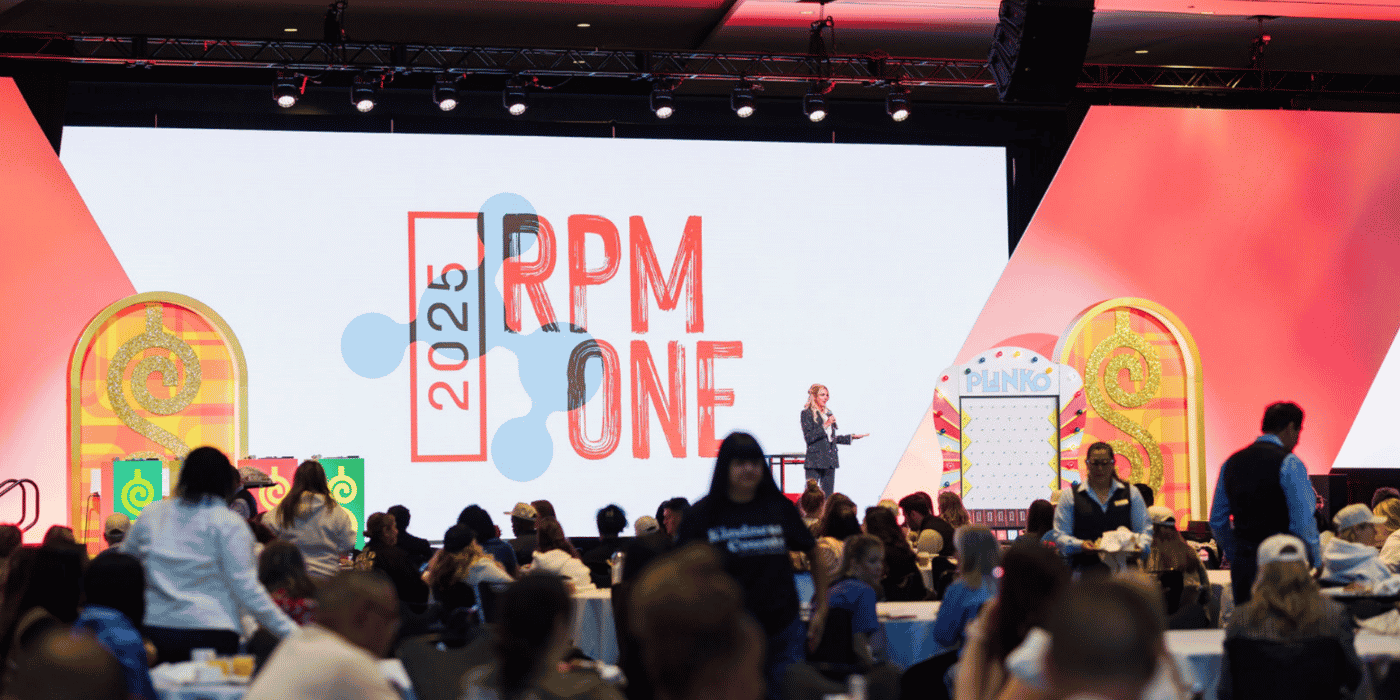 Speaker on branded conference stage with LED wall