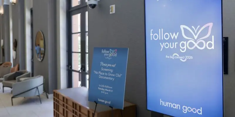 Print sign and LED display showing matching event branding side by side