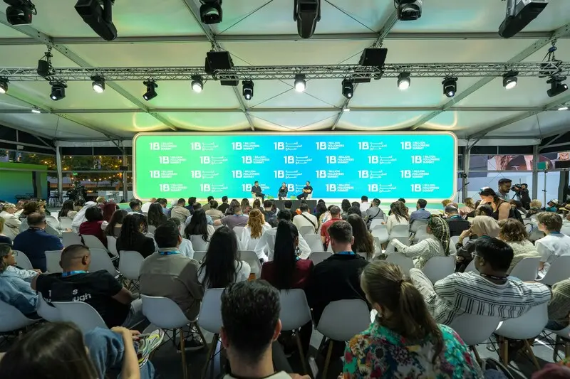 Two speakers on stage at branded outdoor conference
