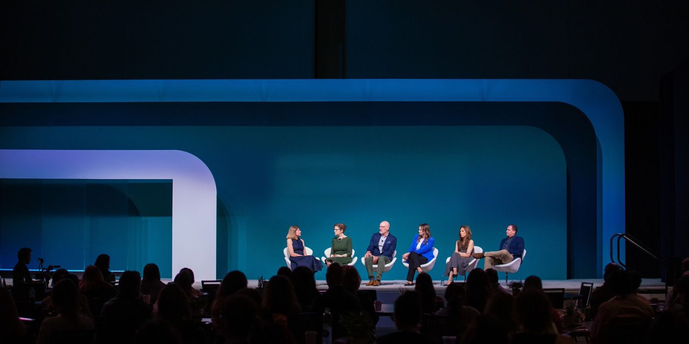 Panel on blue stage with curved scenic frames