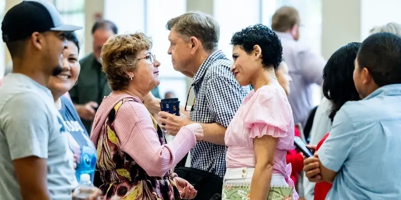 Attendees networking in small groups at a conference